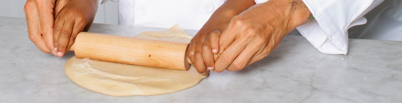 mom and child rolling dough